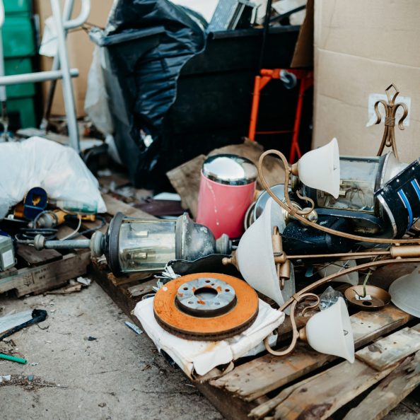 A collection of old and used household goods scattered around in the recycling center